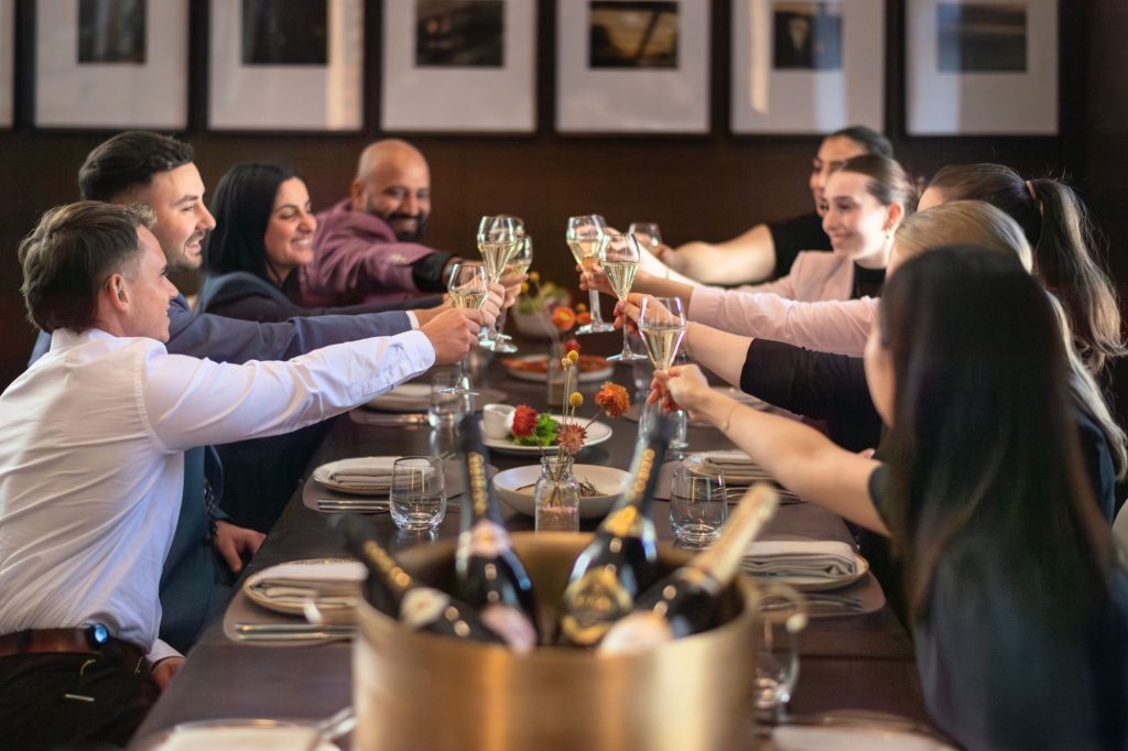 People dining in a restaurant and saying cheers with their glasses of wine